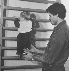 Baby Climbing Up Doorway Gym Bars