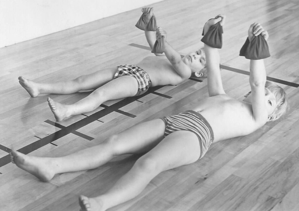 Two boys using weight bags